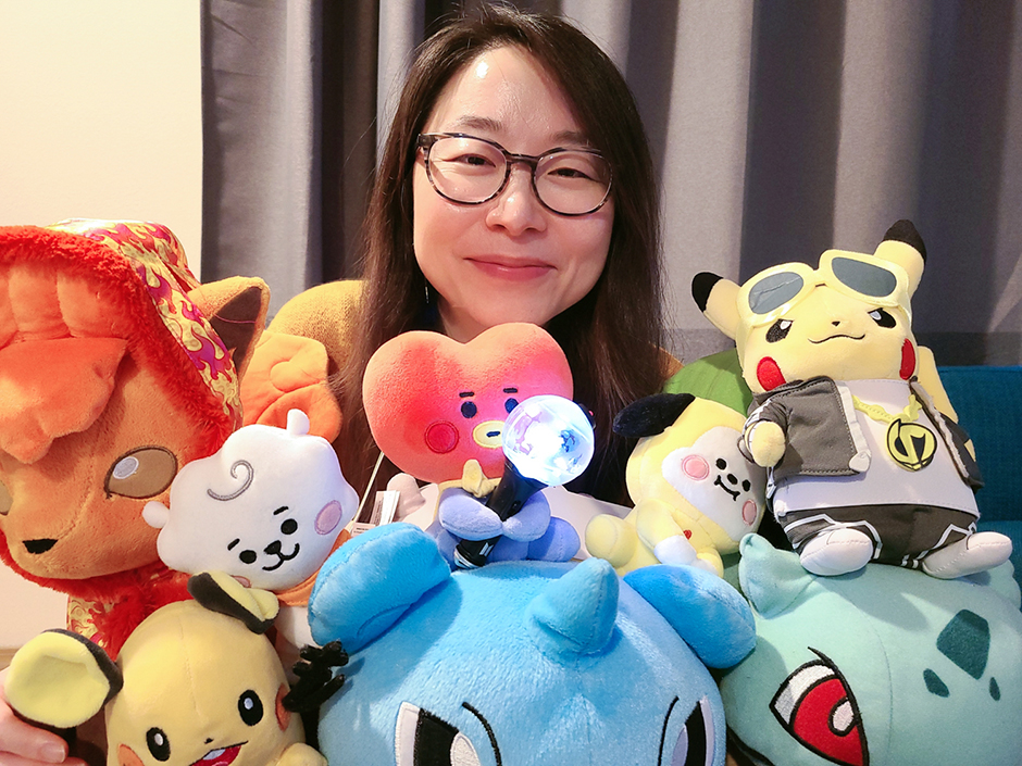 Jin Ha Lee surrounded by toys.